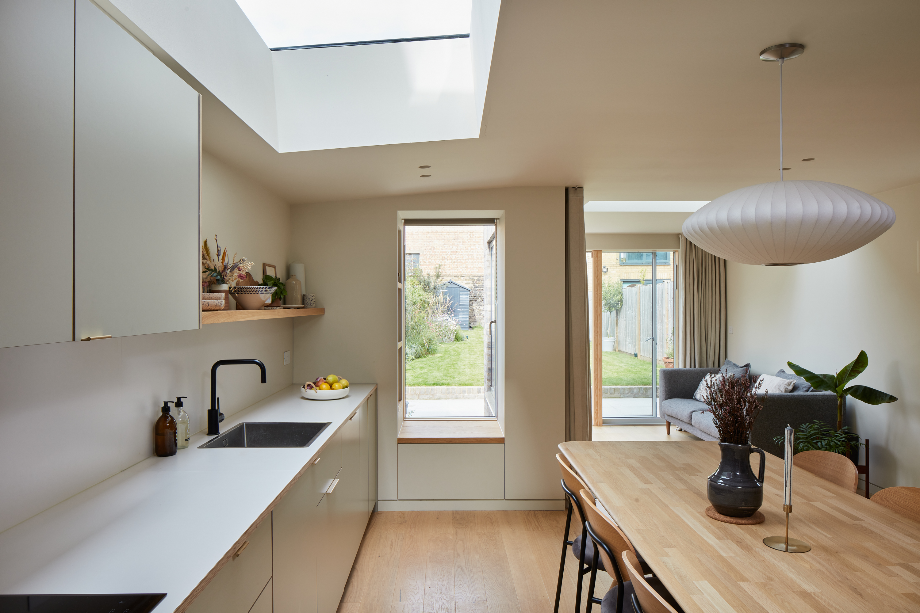 Plykea Formica Seed with brass edge pull handles and a Formica surf worktop