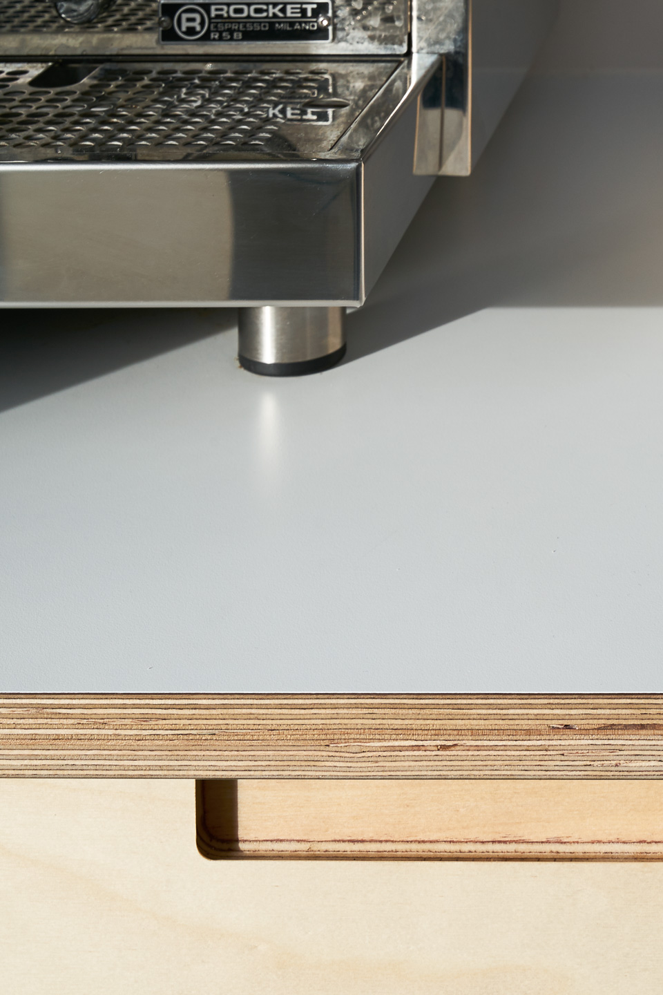 Birch plywood fronts, Formica countertops and semi-recessed grab handles