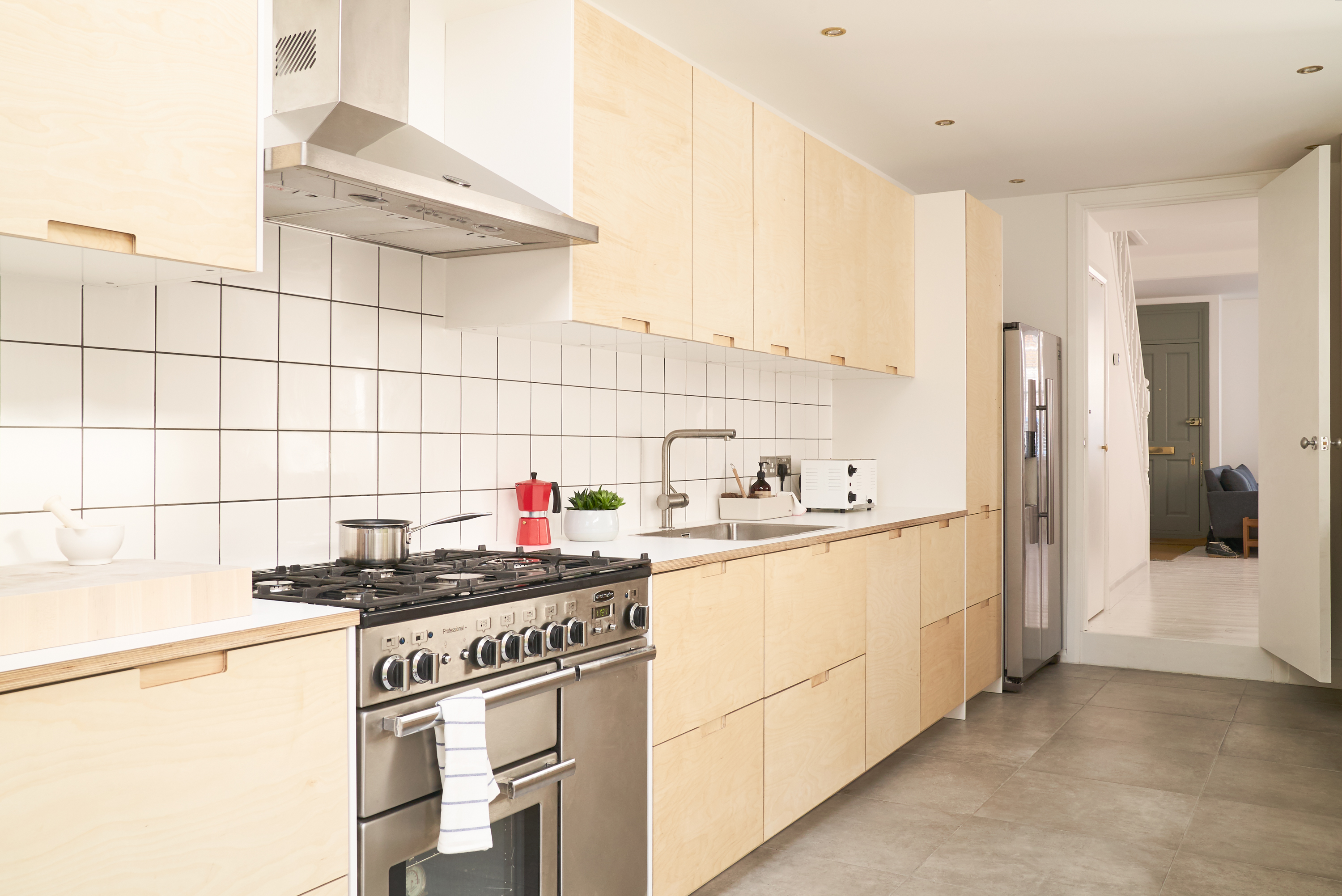 Birch plywood fronts, Formica countertops and semi-recessed grab handles