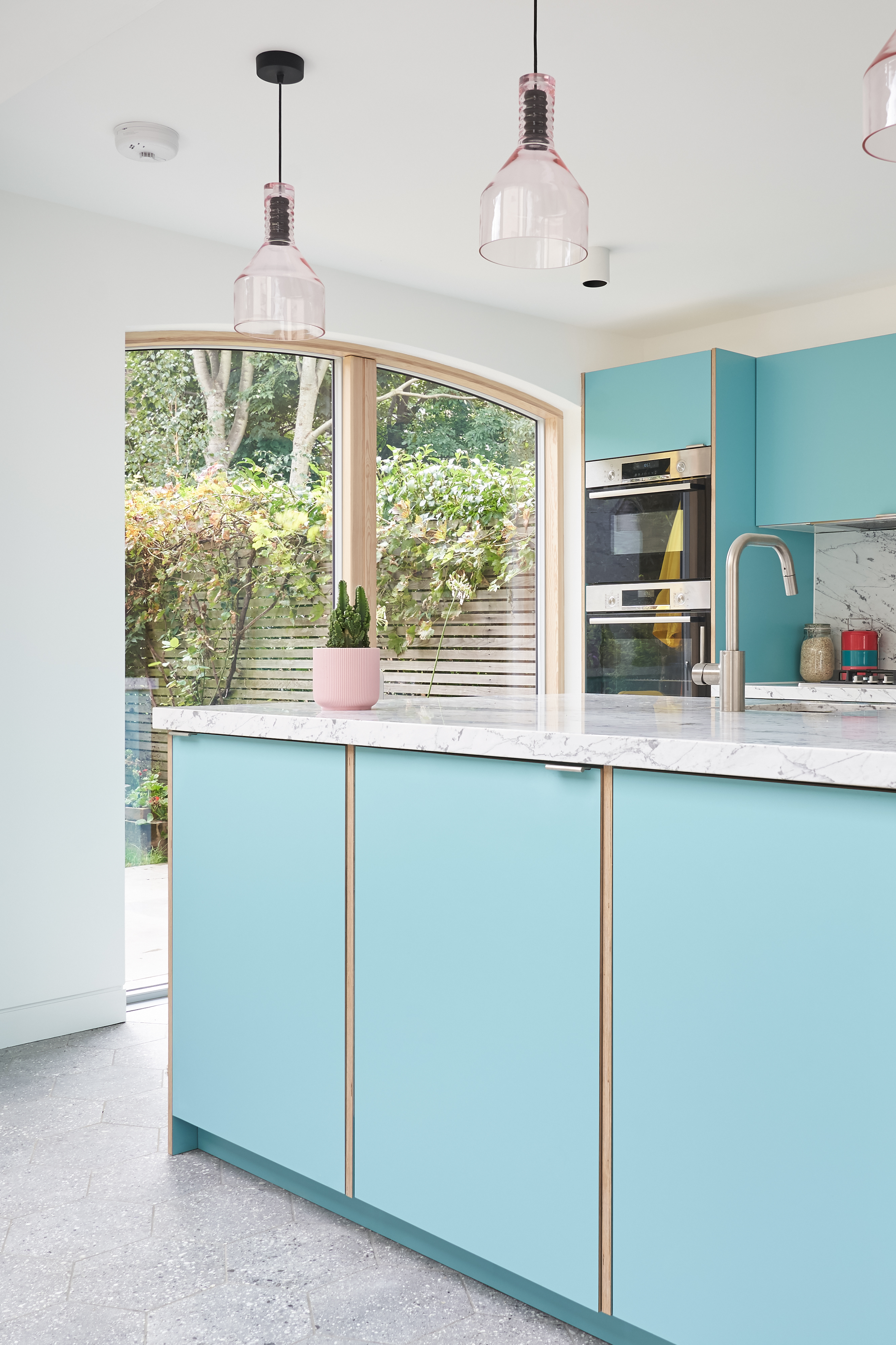 Plykea Formica Maui fronts with nickel edge pull handles and birch ply spacers on the island