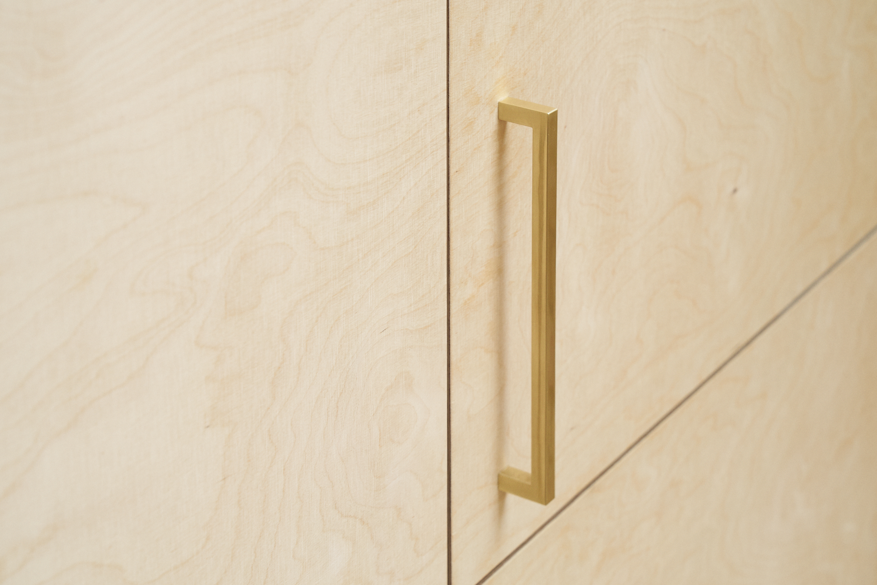 Birch plywood fronts and brass edge pulls handles in our Greville Road kitchen