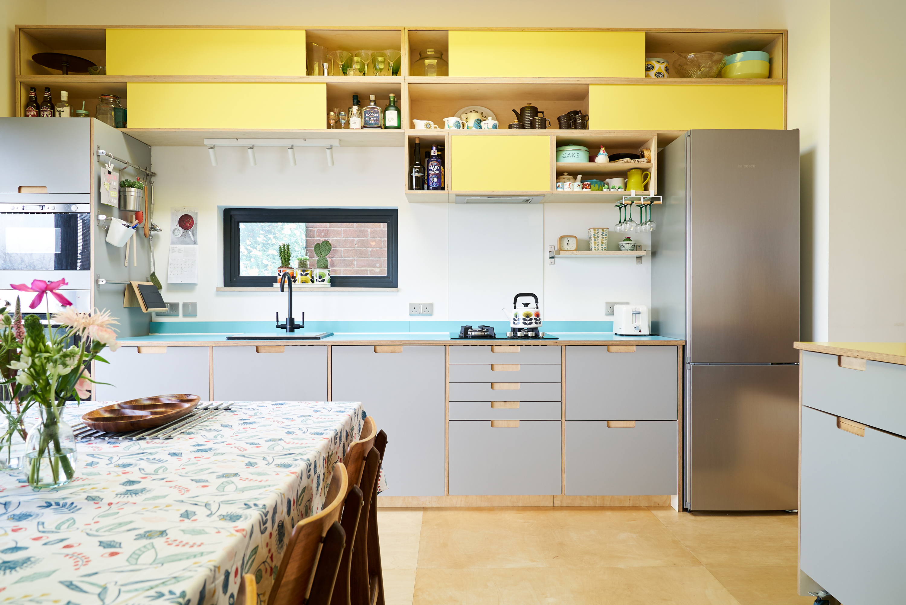Fog and Chrome Yellow Formica fronts with semi-recessed handles in our Orchard Way kitchen