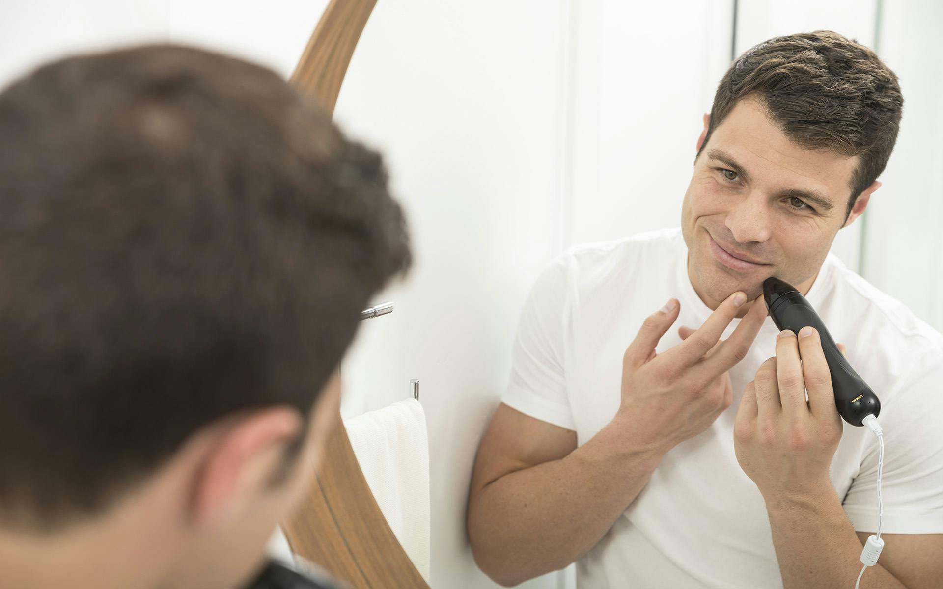 Man treating his face with Personal Microderm Pro 