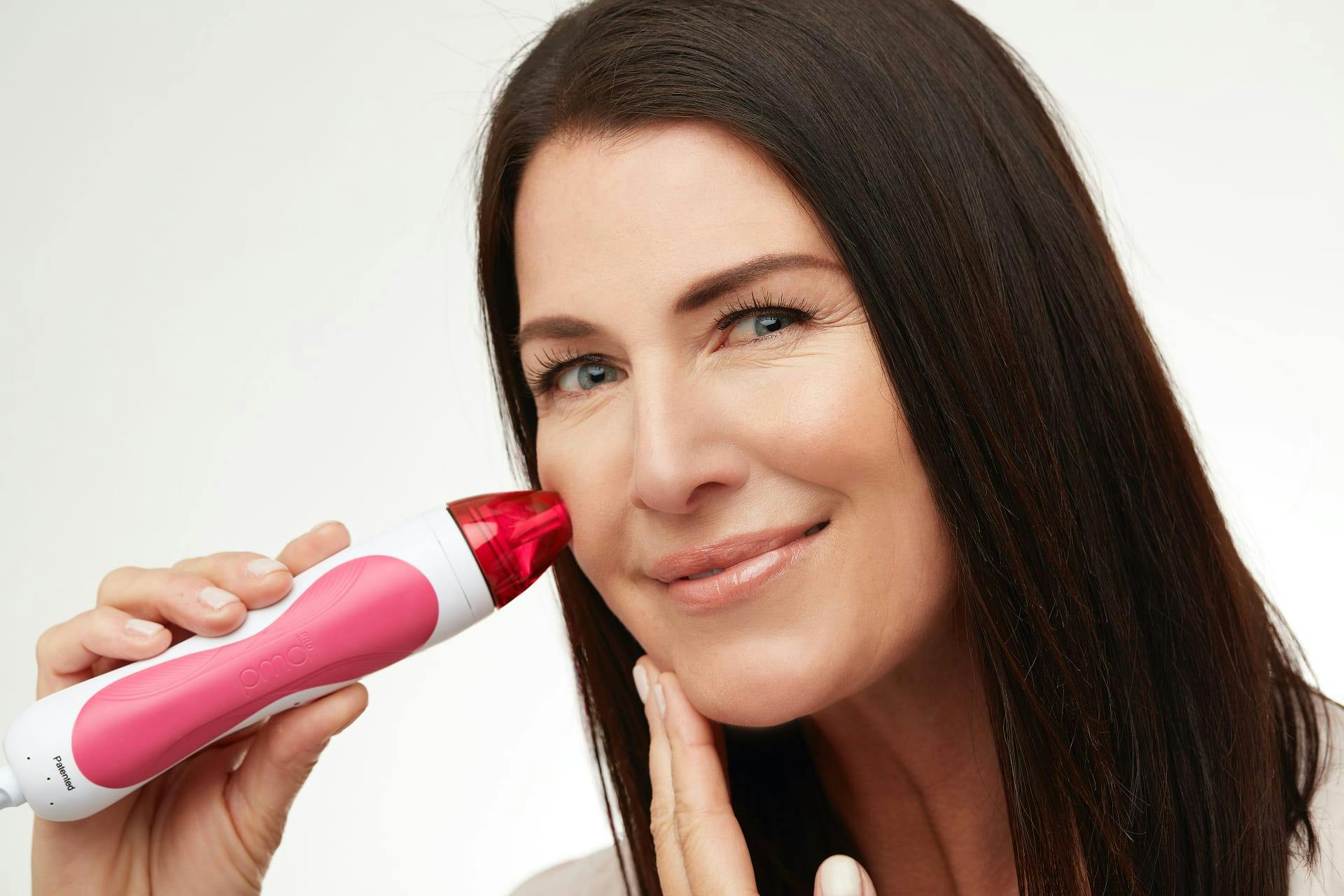 Woman using Personal Microderm Pro on face