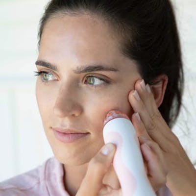 Woman using Personal Microderm Classic on face