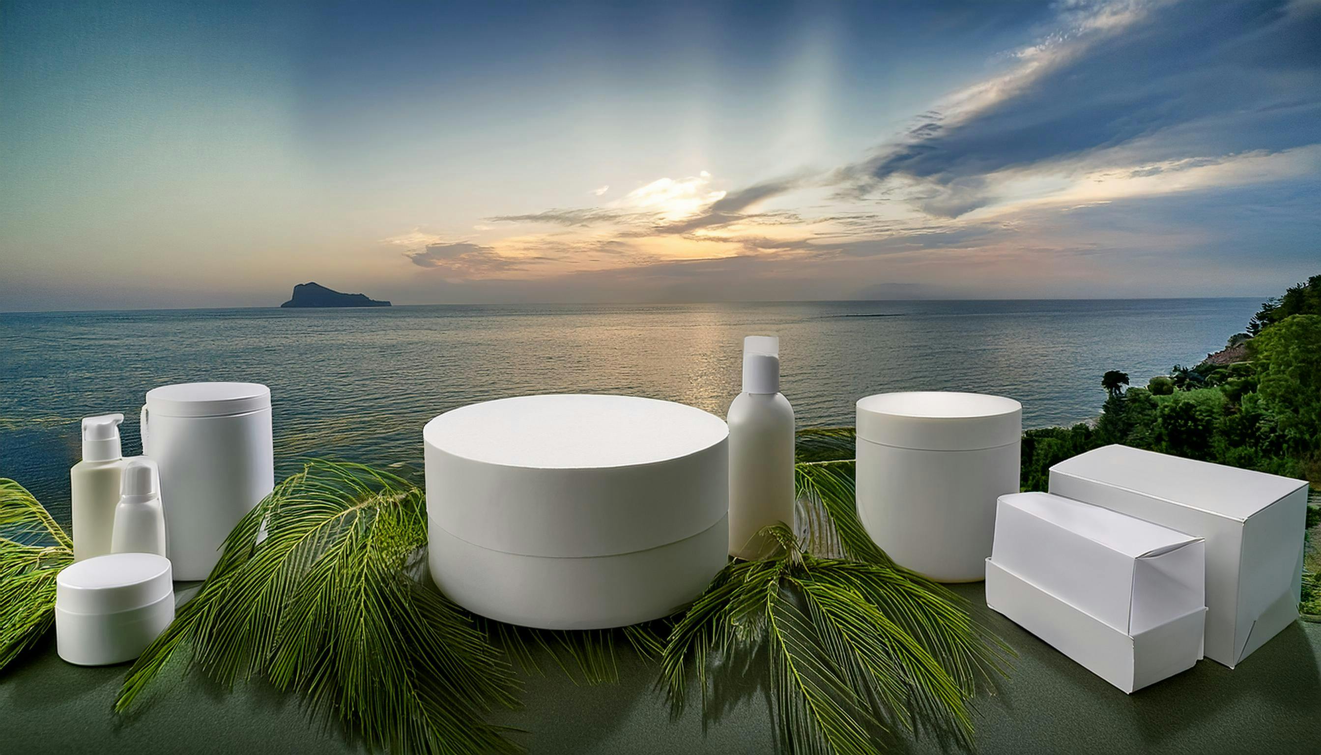 Variety of boxes overlooking an ocean on a stone table.