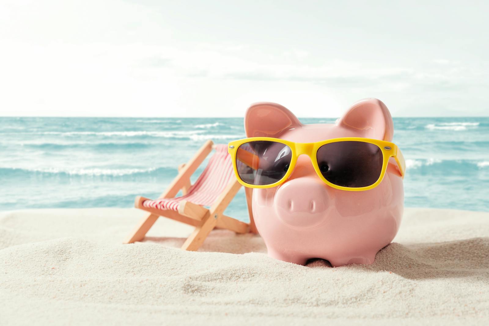 Piggy bank resting on vacation. Saving money, travel concept