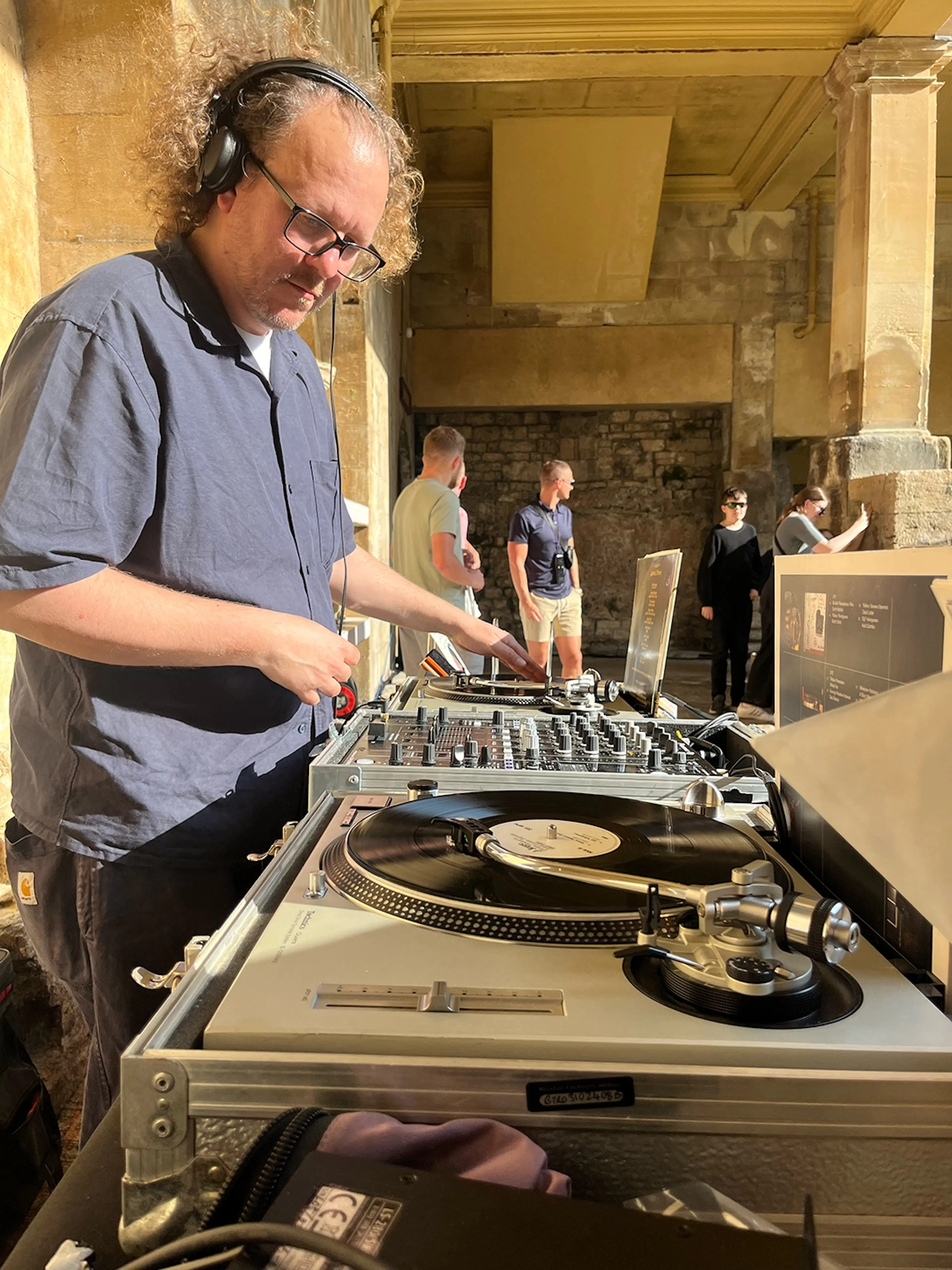 DJ Veto playing vinyl records inside the Roman Baths.