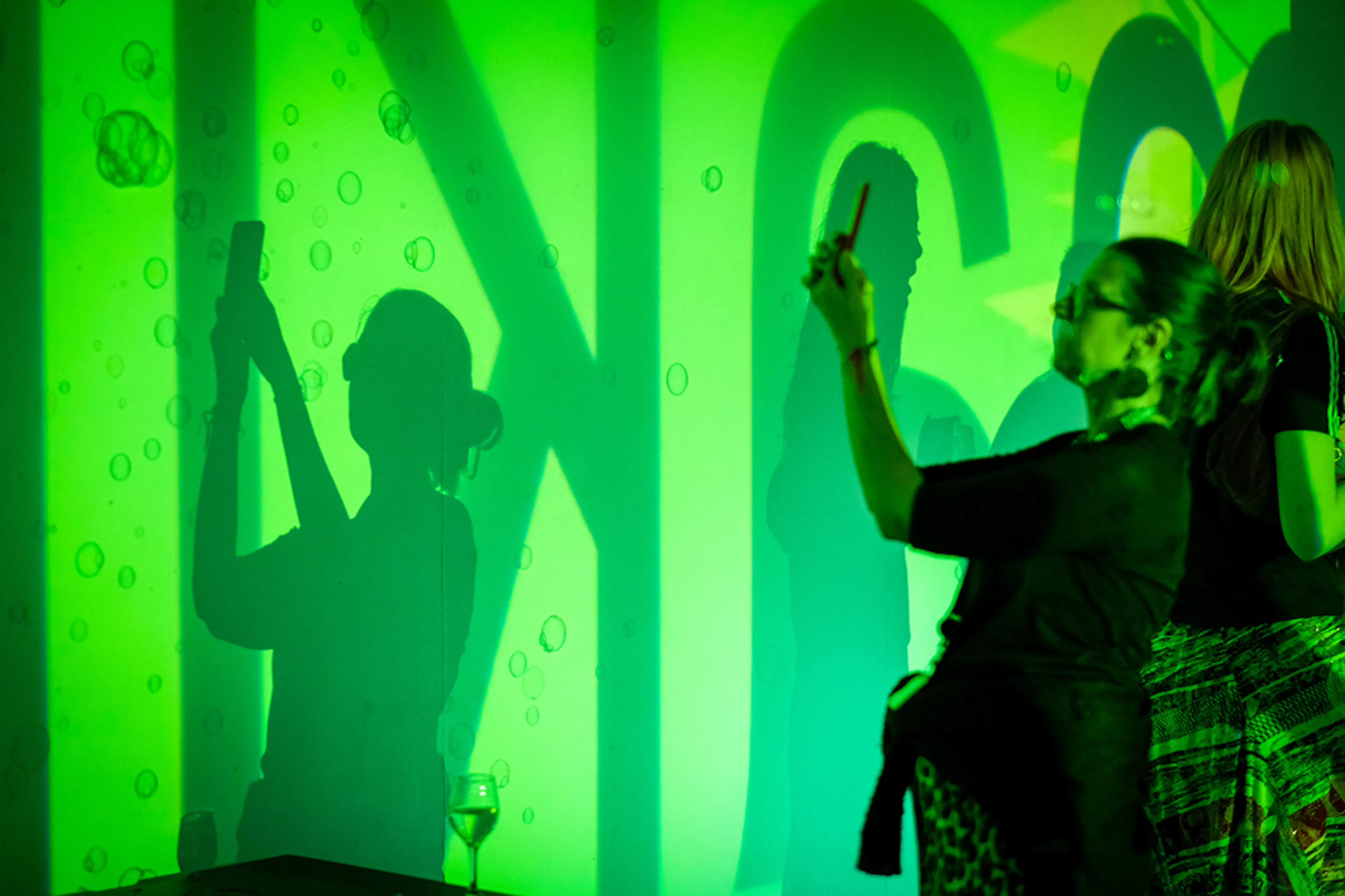 Stacey Pottinger taking pictures of the live coded visual projection.