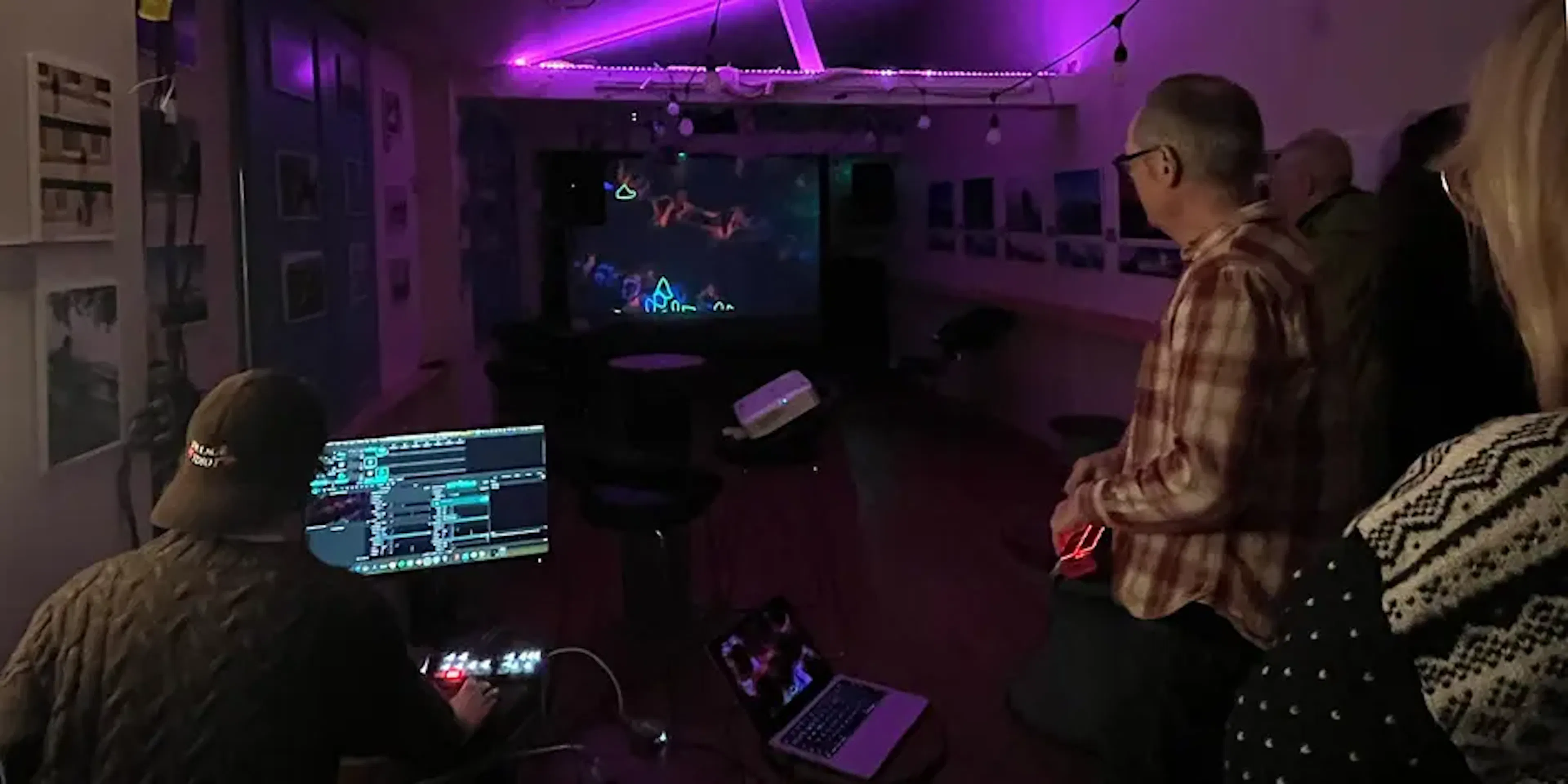 A wide shot of Felix Colbert showing audience members work at the audio visual meet-up.