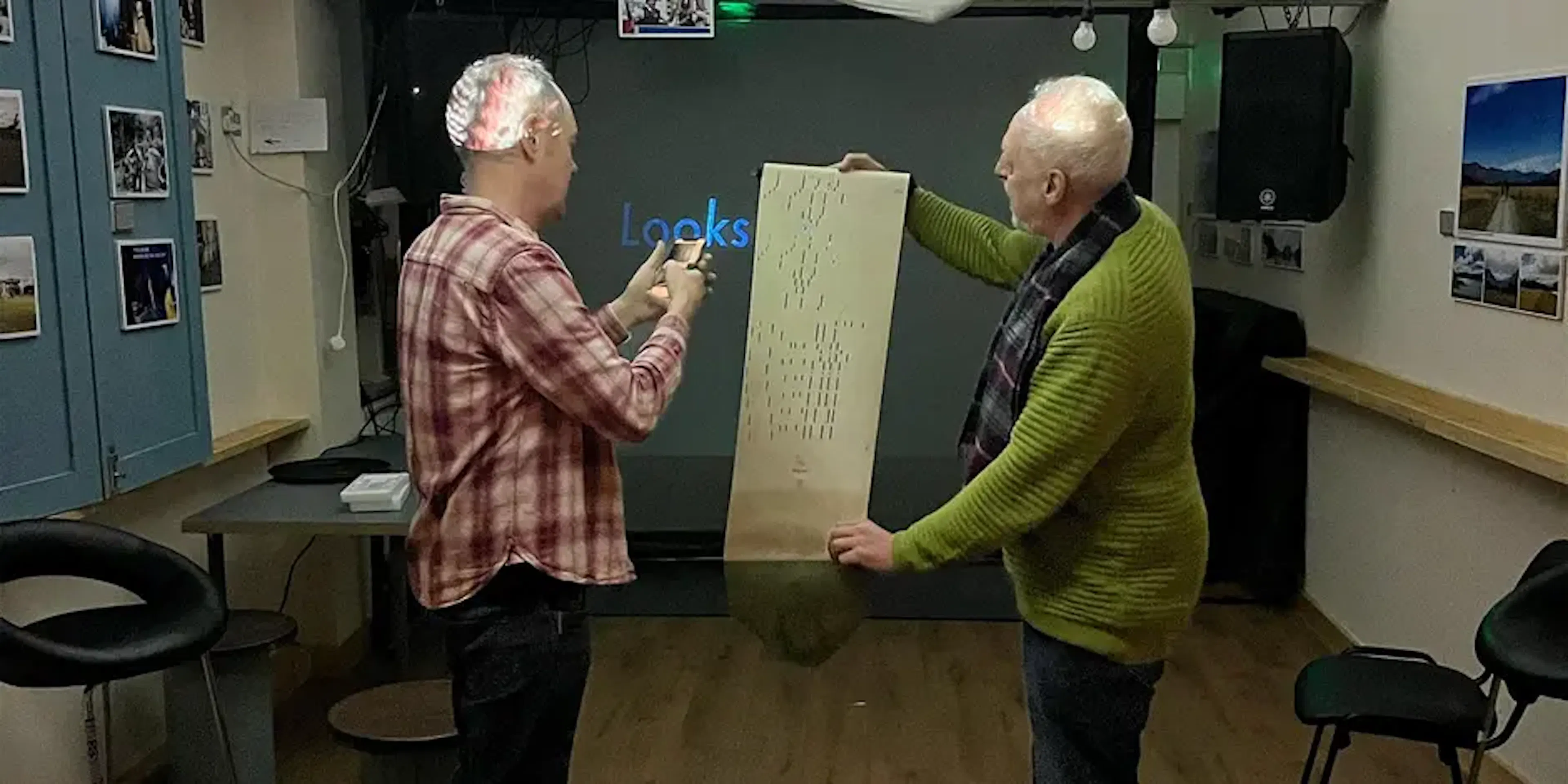 Dave Webb and Brian Gibson showing Brian's paper-based work at the audio visual meet-up.