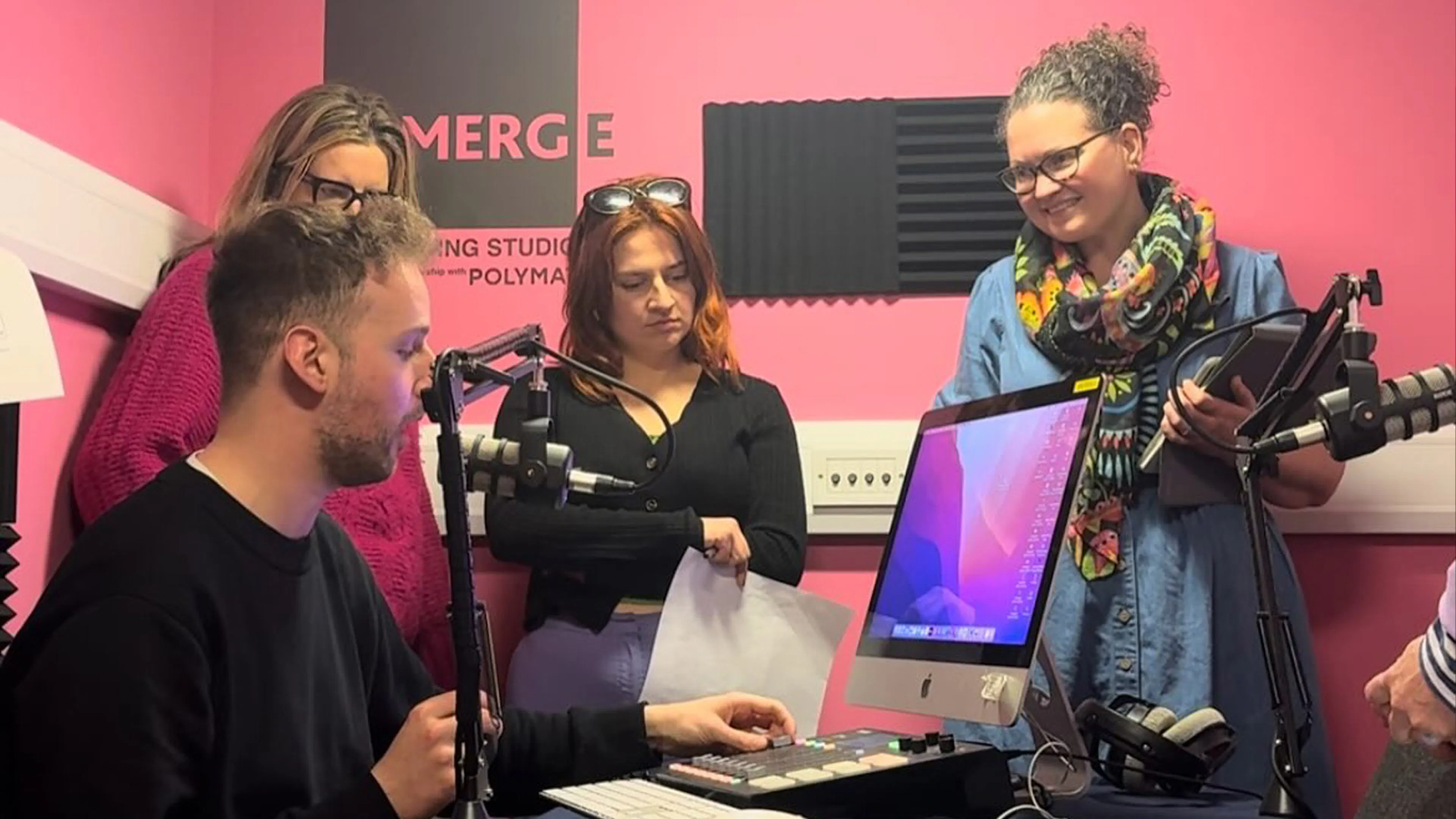Nigel Fryatt with workshops participants showing them the equipment in the EMERGE podcasting room.