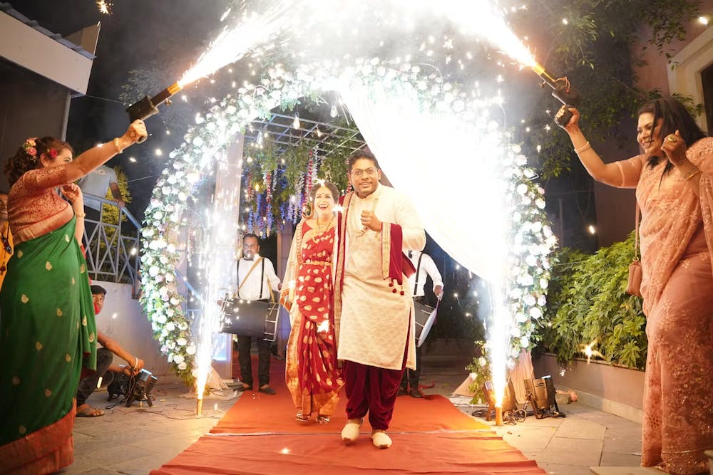 Couple walking down through a dome-shaped wedding gate