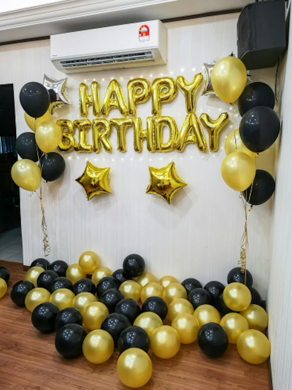 Black and golden combination of balloon decoration for birthday function