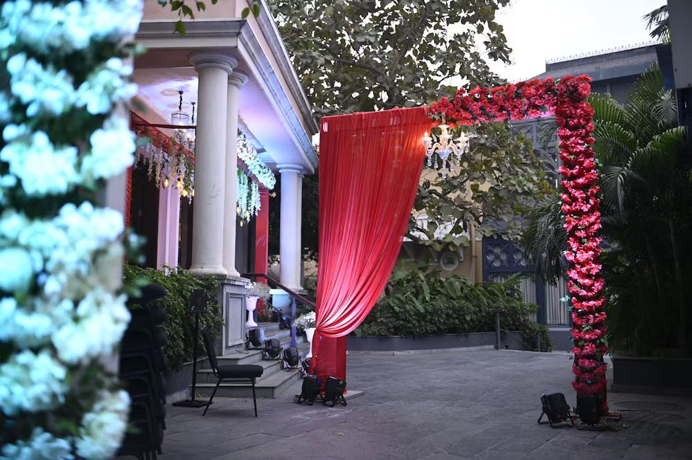 Fancy red colored decorated gate with curtains and red flowers