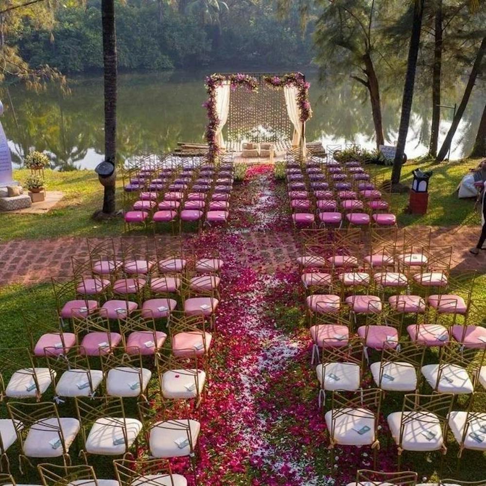 Pink and white wedding stage amidst nature