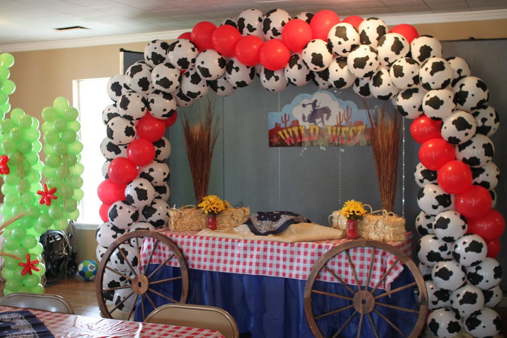 White balloons with black imprints in the shape of an arch image