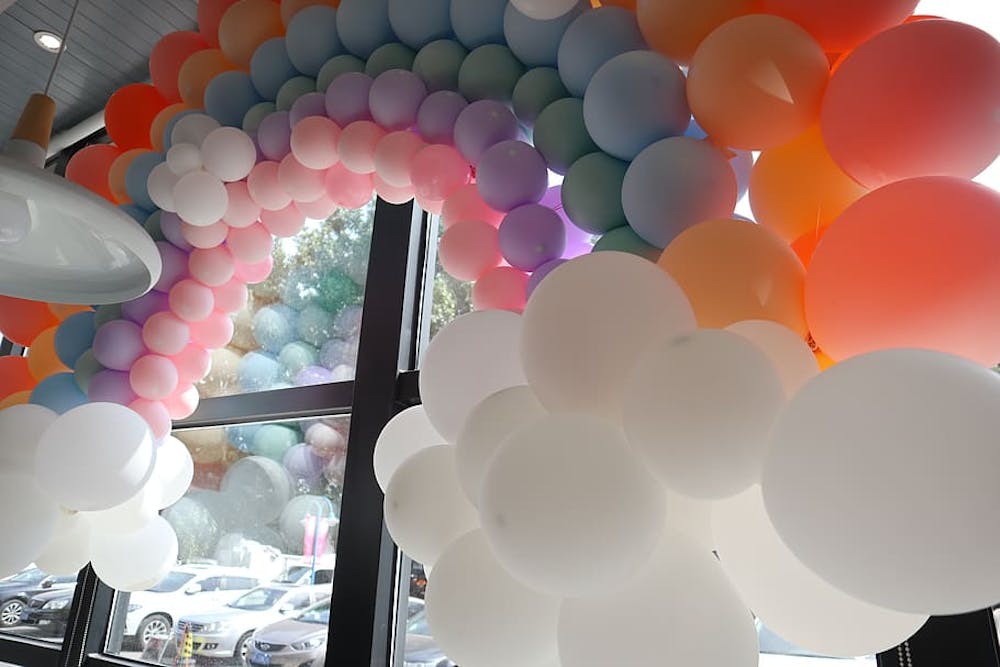 A rainbow looking balloon arch picture
