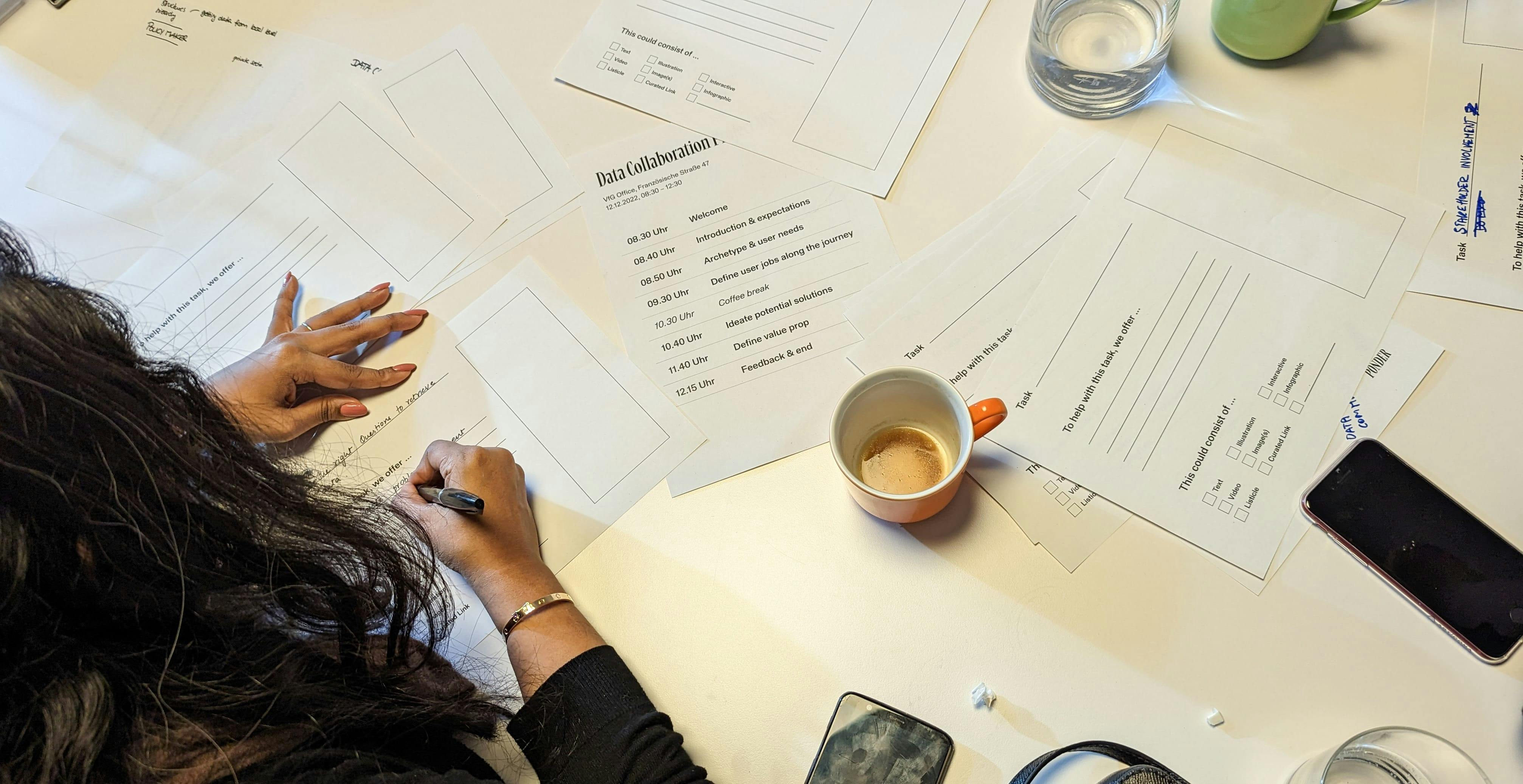 close-up of a person filling our a worksheet in our workshop