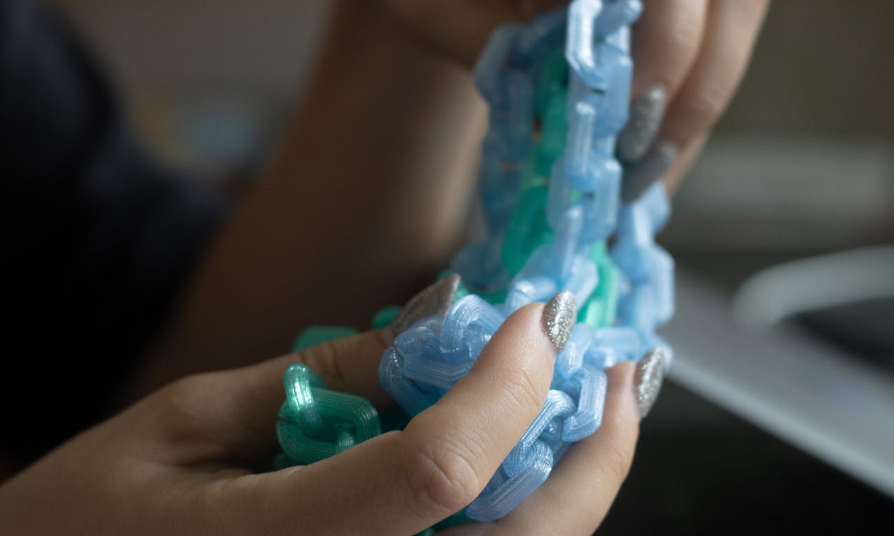 A detail photo of Caro holding rahrah chains
