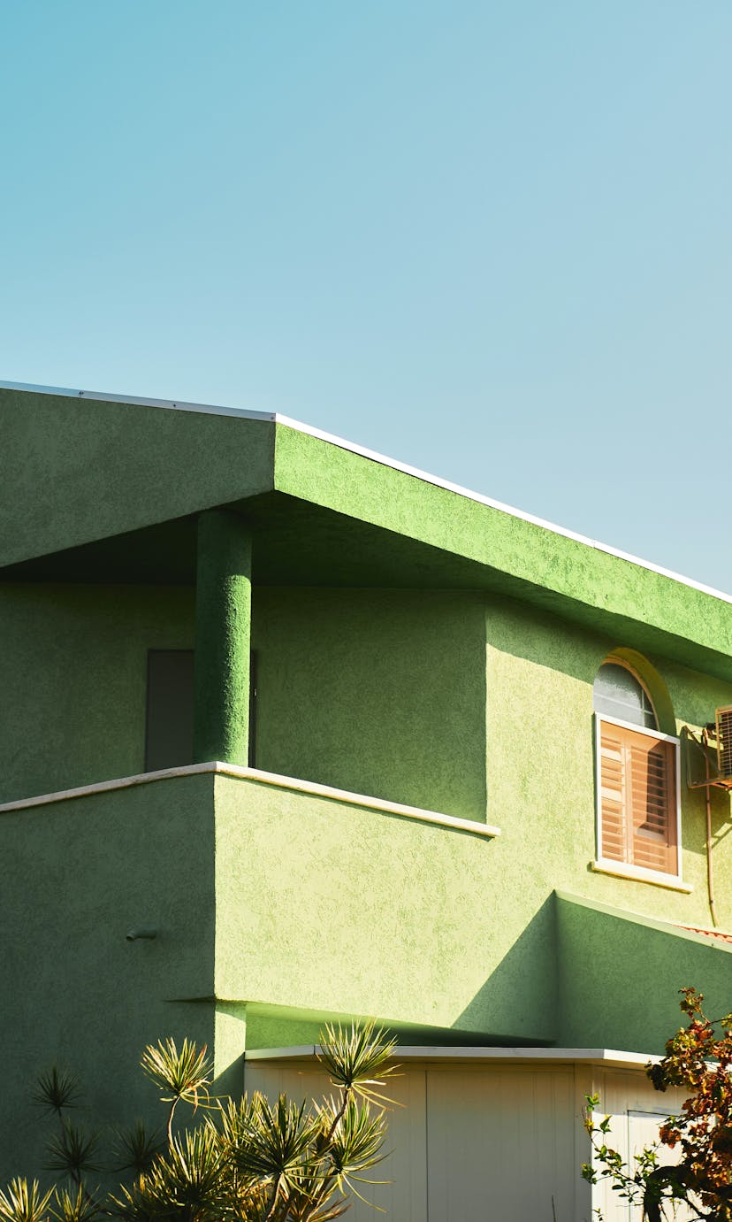 A house with green stucco walls
