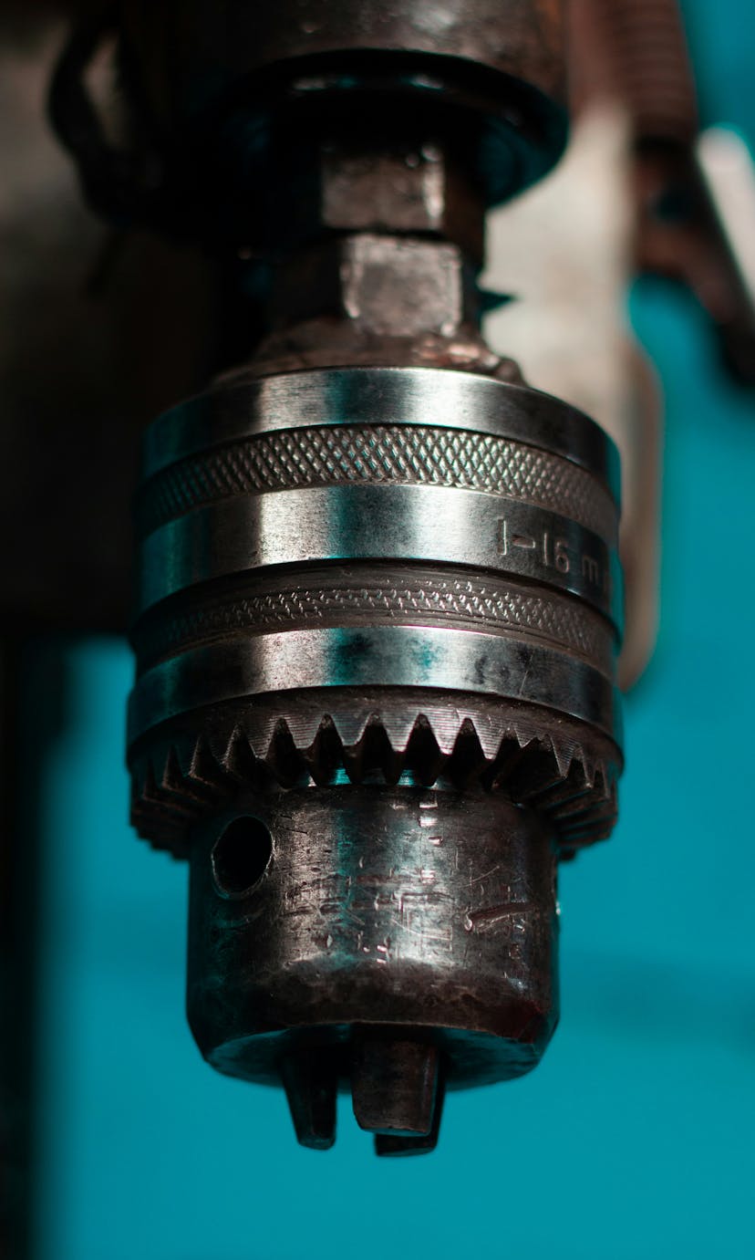 A close-up of a drill press chuck