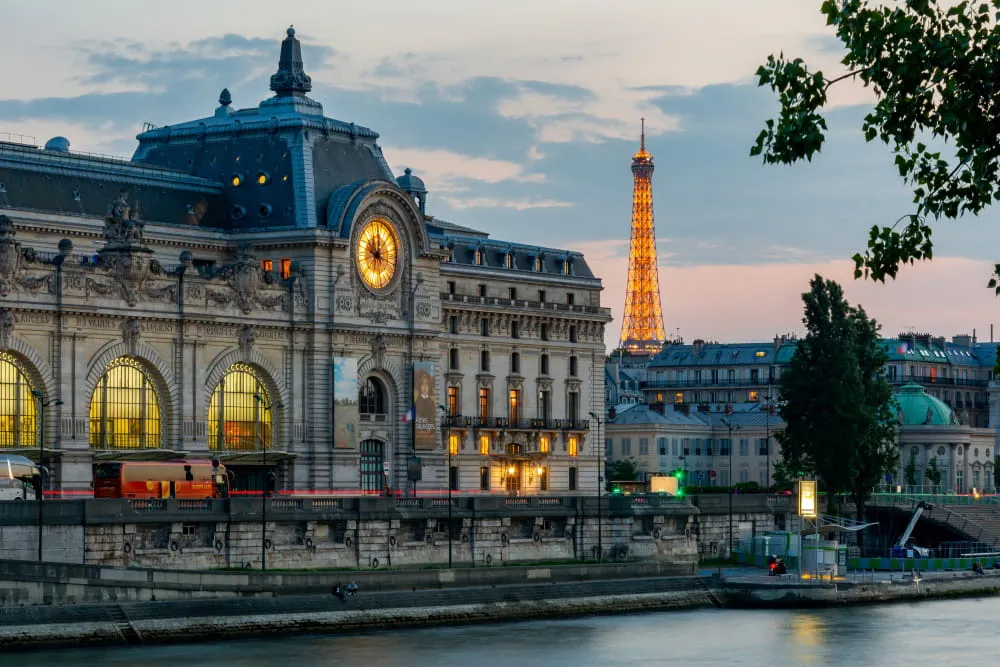 Le Musée d'Orsay, son impressionnante horloge et la Tour Eiffel en fond depuis les quais de Seine dans le 7eme arrondissement de Paris.© Vladislav Zolotov