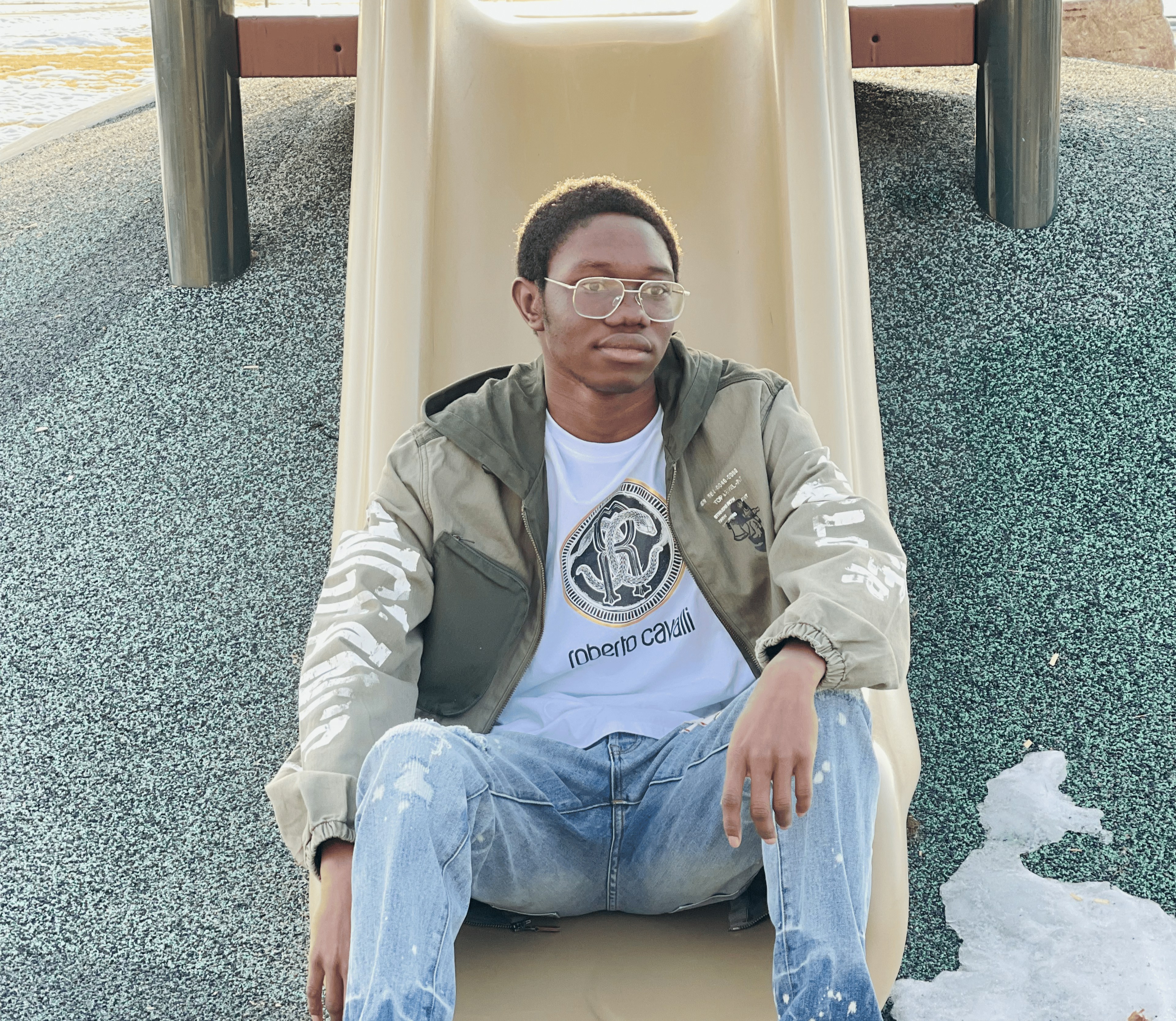 Me sitting on a slide looking to the right