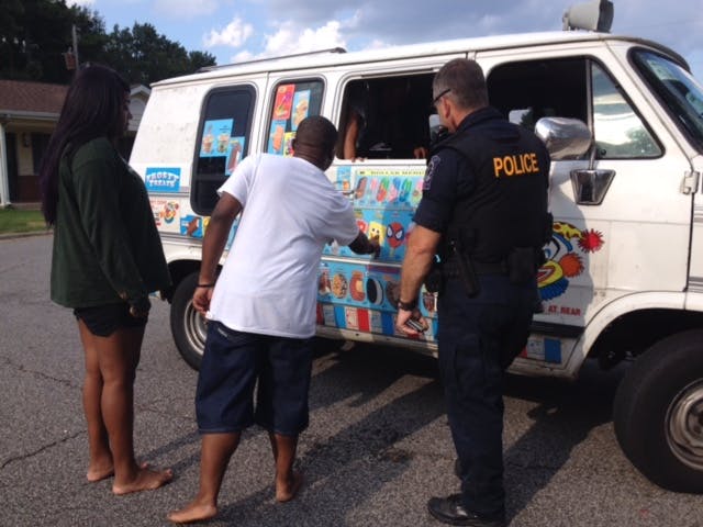 K9 police officer buying ice cream from truck