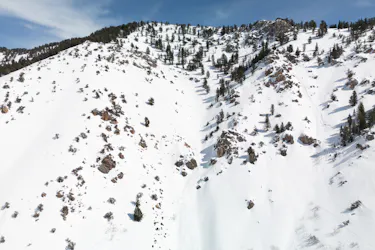 Aerial view of DMI terrain. It is very steep with some trees and rock faces.