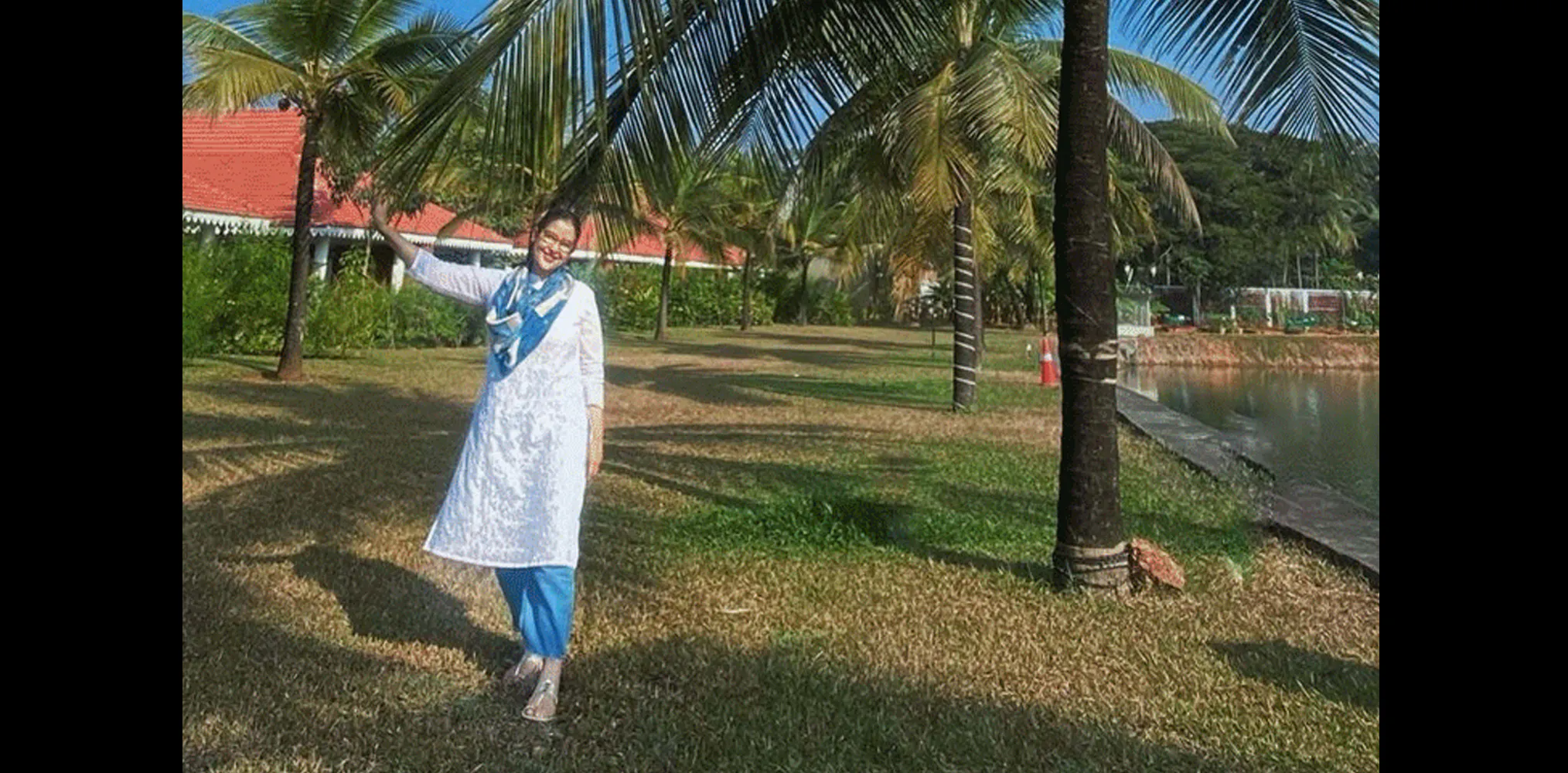 Manisha enjoys the coconut trees, soft skies