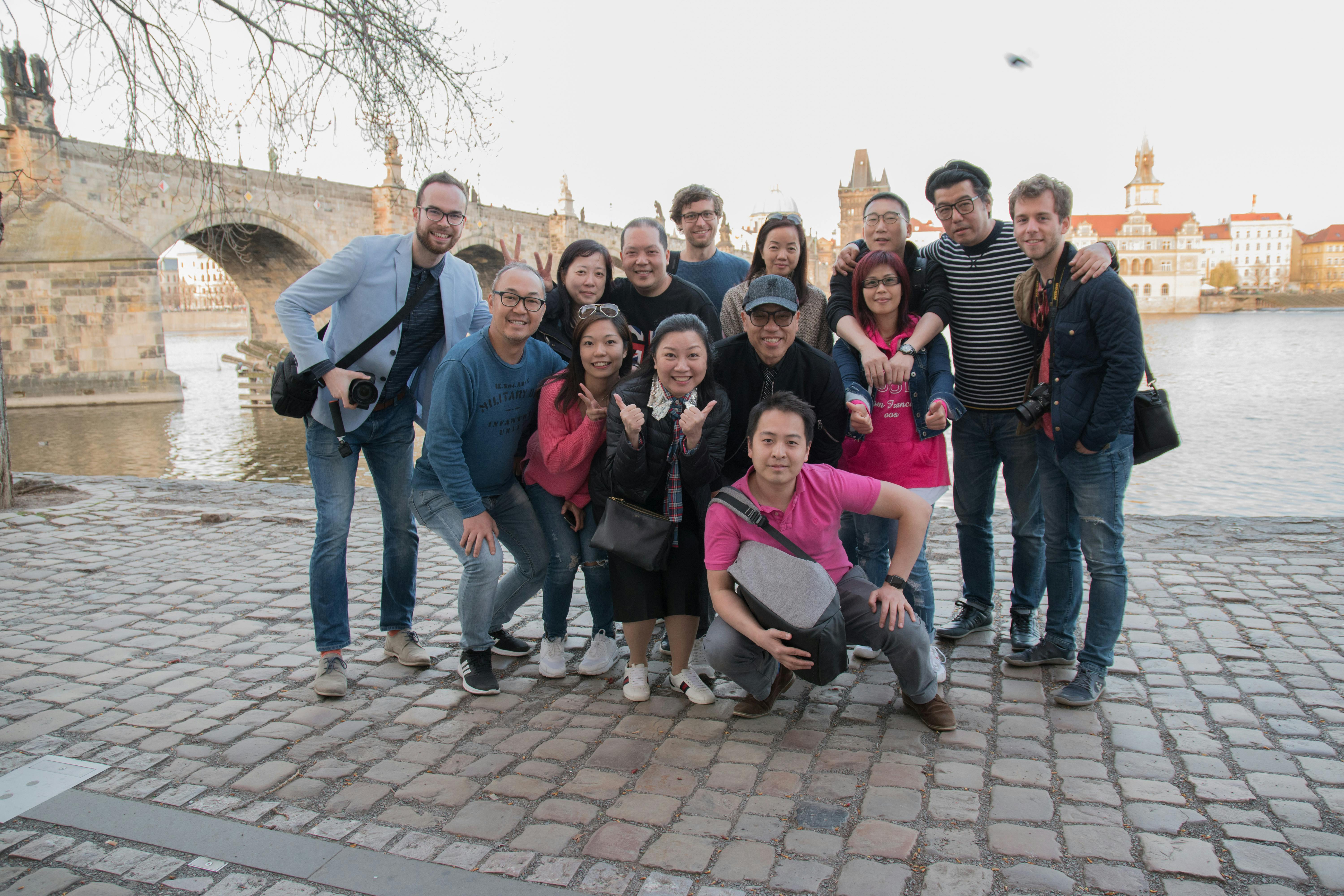 Behind the scenes photo of a team from a video shoot event with our clients from Hong Kong next to the Charles Bridge.