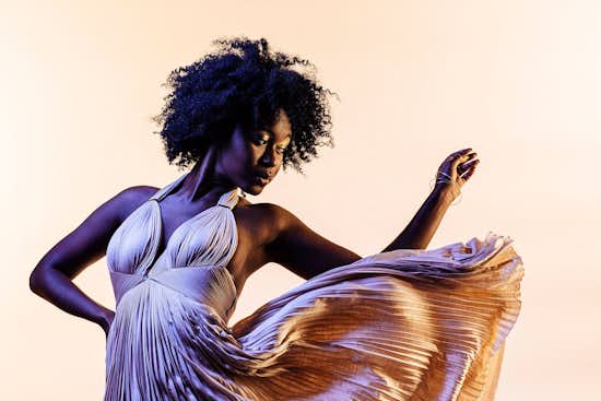 Woman wearing unique fashion gown Woman wearing unique fashion gown