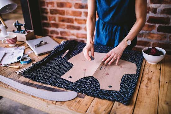 Fashion designer cutting out fabric bodice Fashion designer cutting out fabric bodice