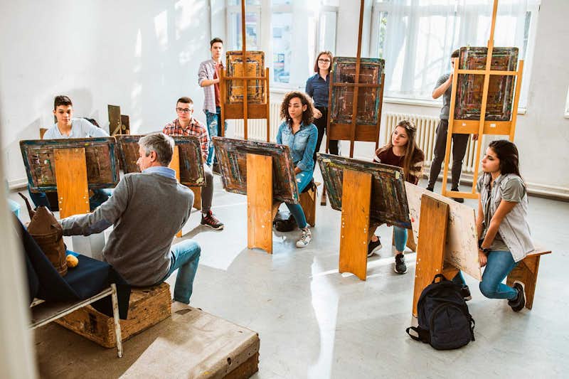 High School students taking art course