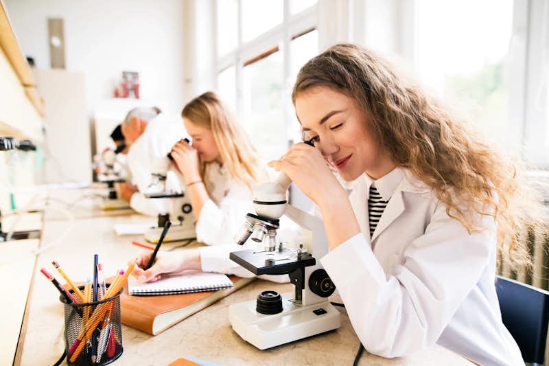 Decorative: High School student learning about medicine with microscope 
