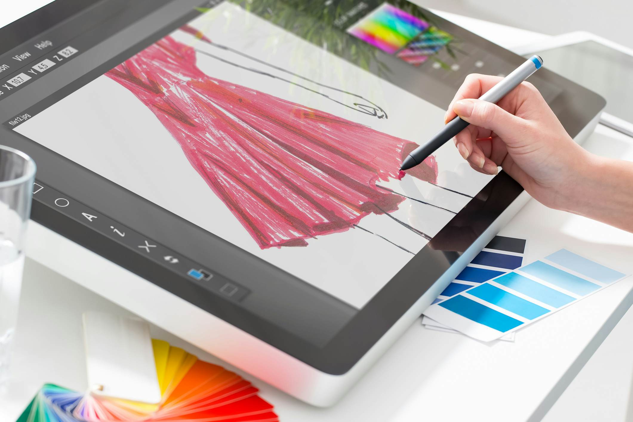 Student sketching a dress on a tablet