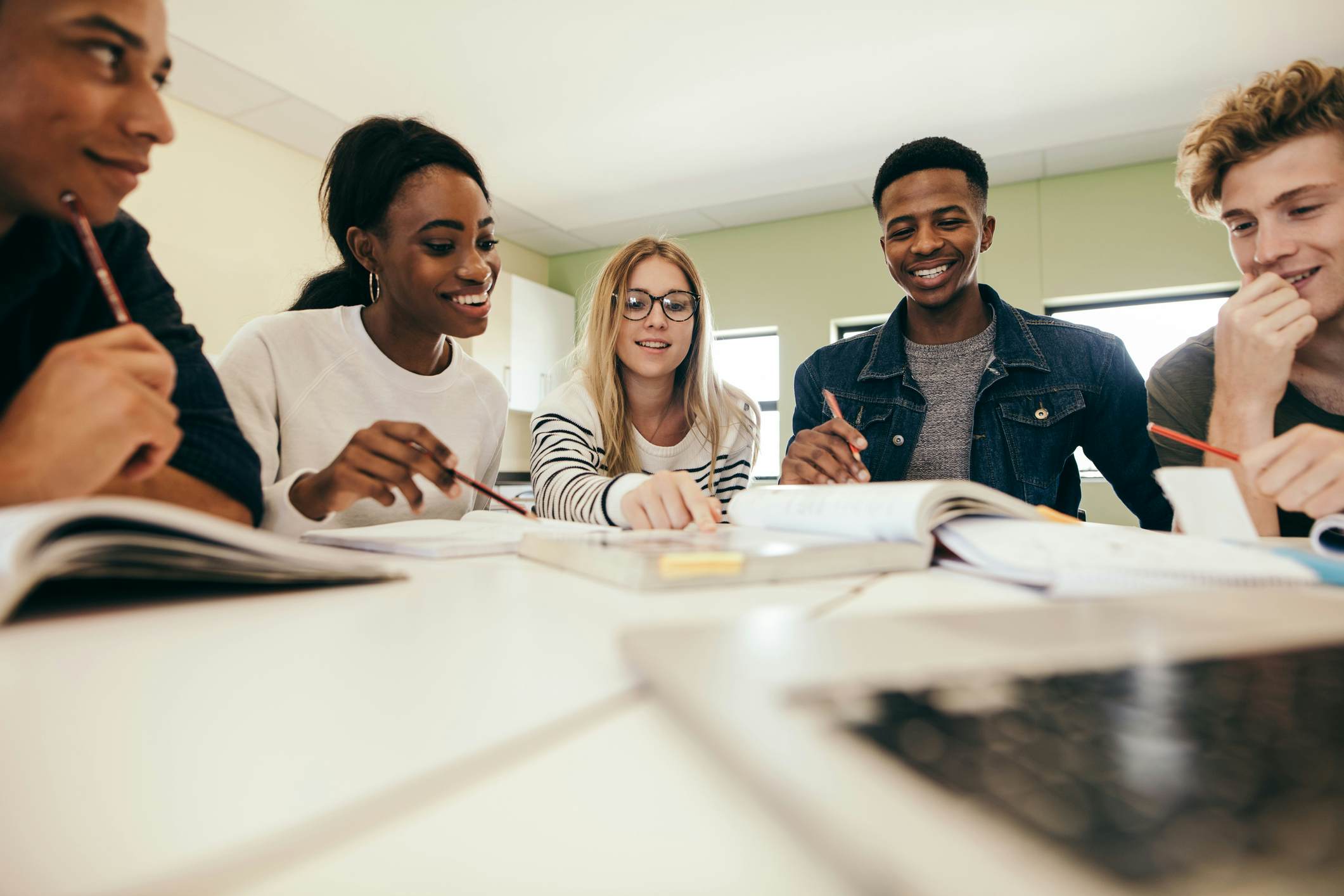 Group of students sitting around a table working together 