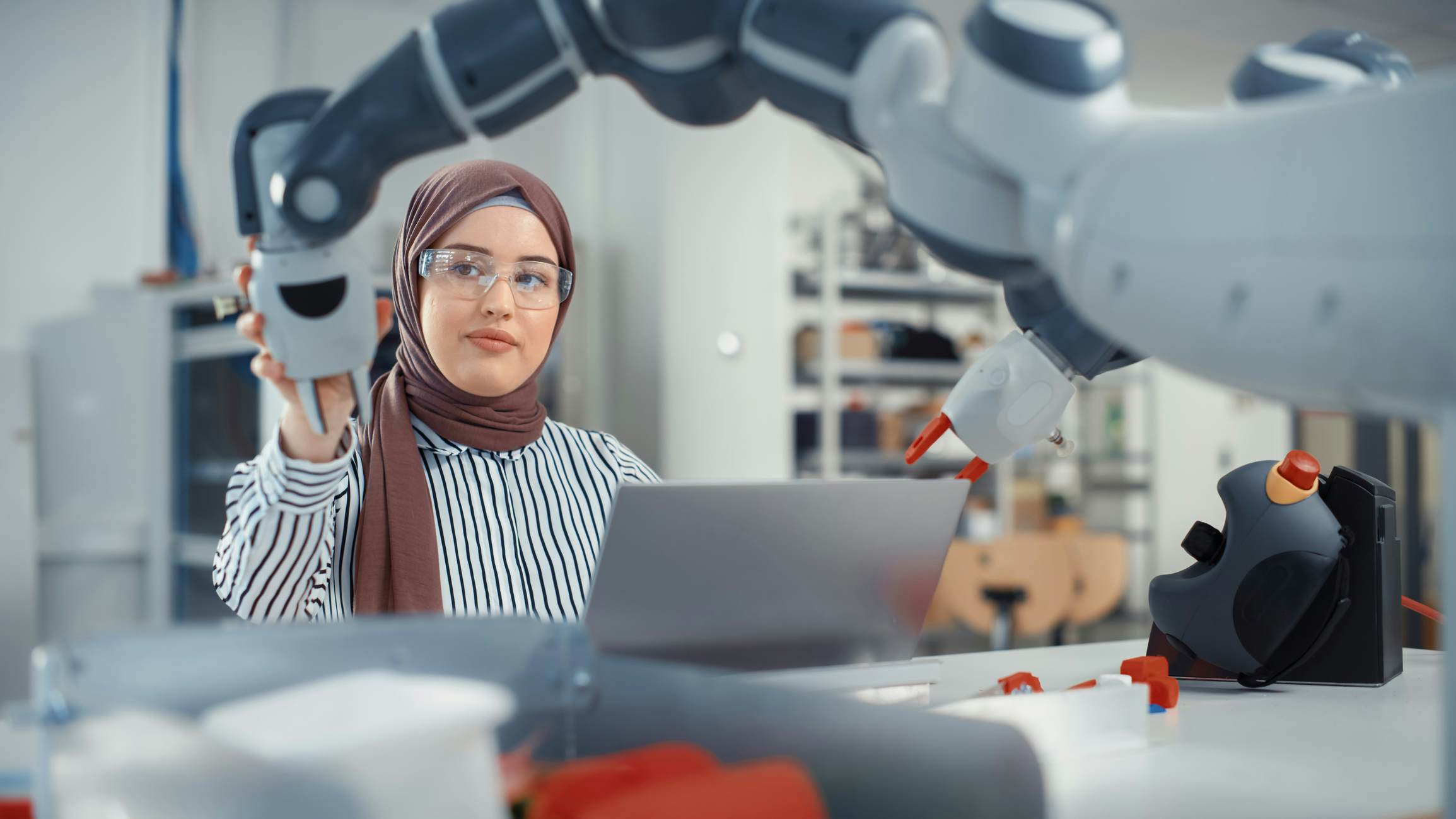 Student working with a robotic arm