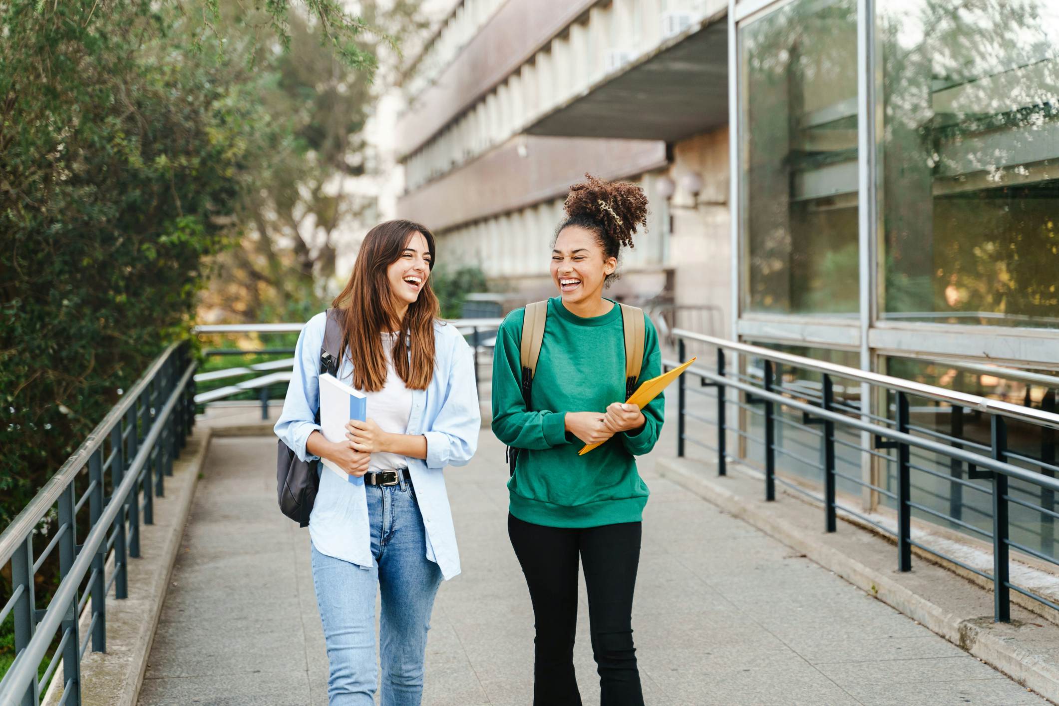 Two female students walking together on a college campus