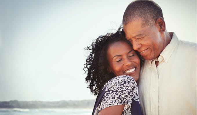 happy couple embracing on the beach.