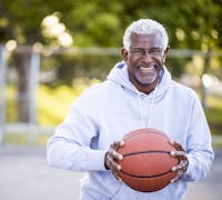 happy man playing basketball