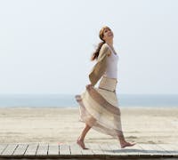 carefree woman walking at the beach