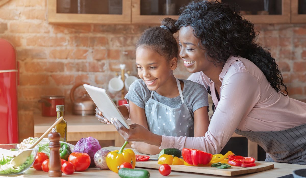 mom and daughter reading a recipe