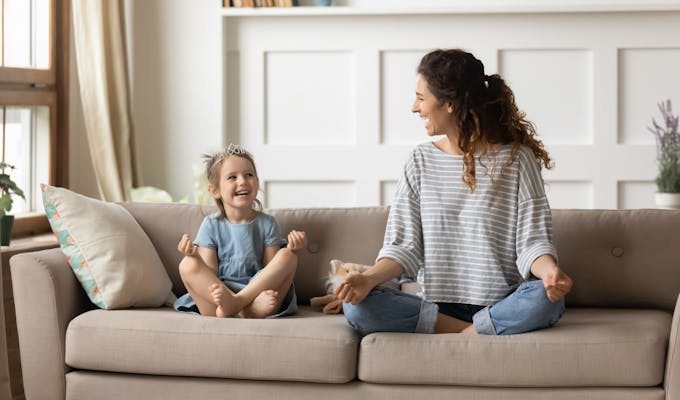 happy mom and daughter practicing yoga