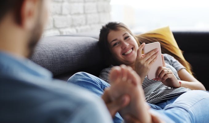 man massaging wife's feet