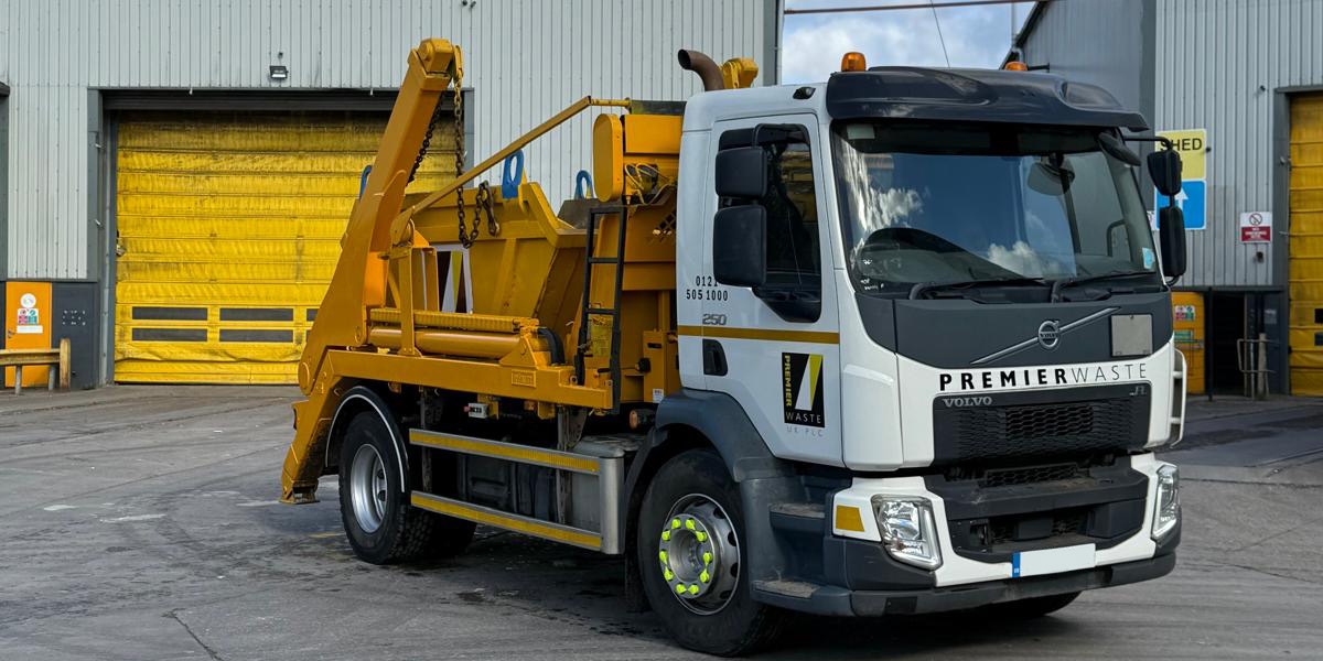 Skip collection truck