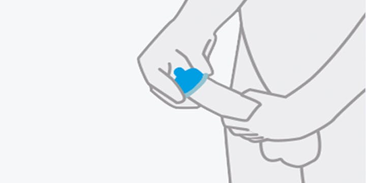 Place the condom on the head of the erect, hard penis