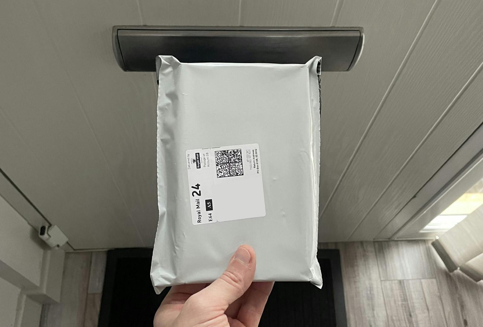 Shows a discreetly packaged Test Kit being picked up after delivery
