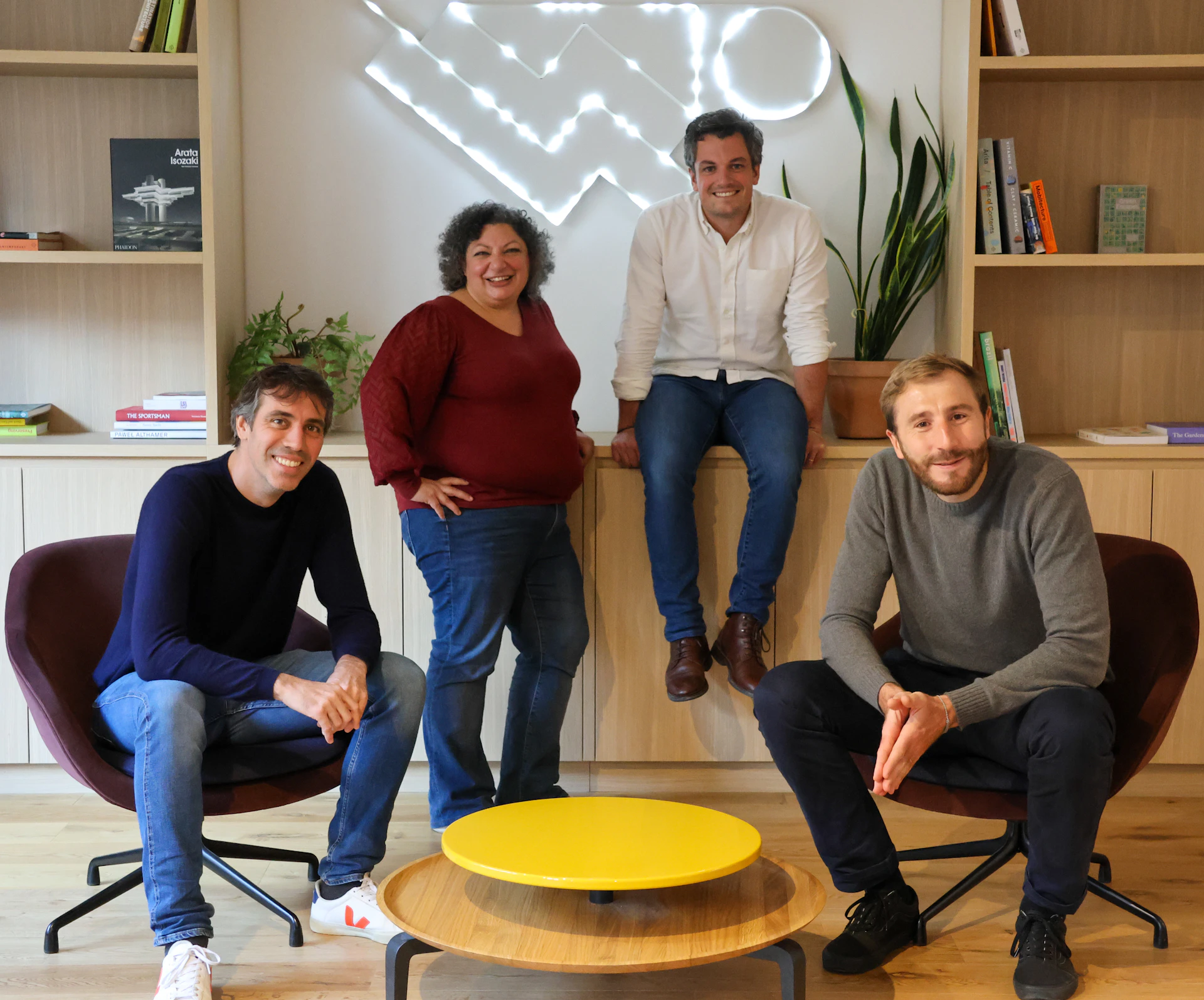 Primary's multidisciplinary founding team of three men and one woman, posing in a welcoming lounge.